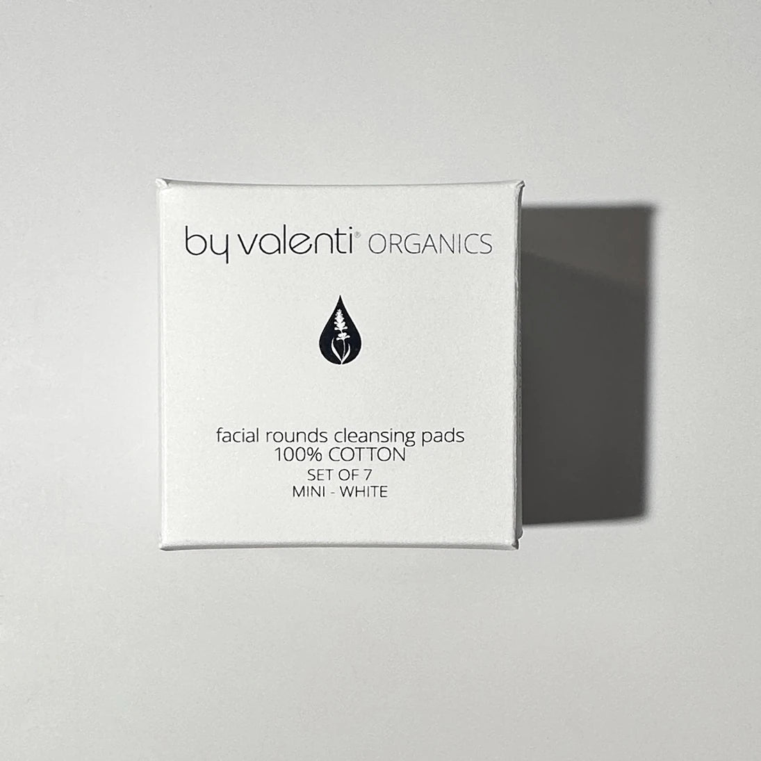Box of by valenti Organics facial rounds cleansing pads on a light gray background
