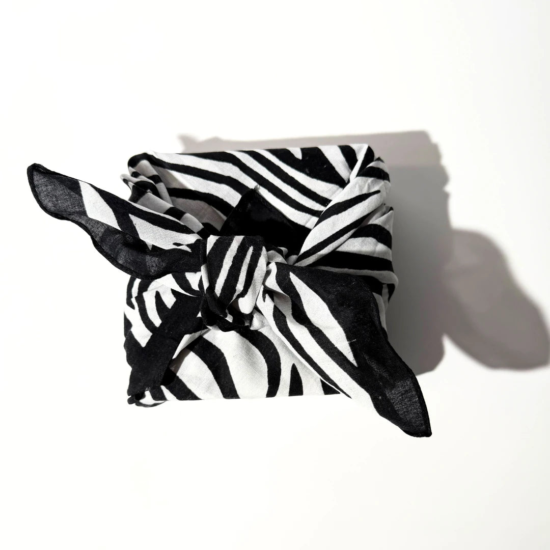 By Valenti black and white zebra-striped gift wrapped furoshicana on a white background