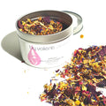 Bath and facial steaming tea with colorful herbs in a By Valenti Organic tin.
